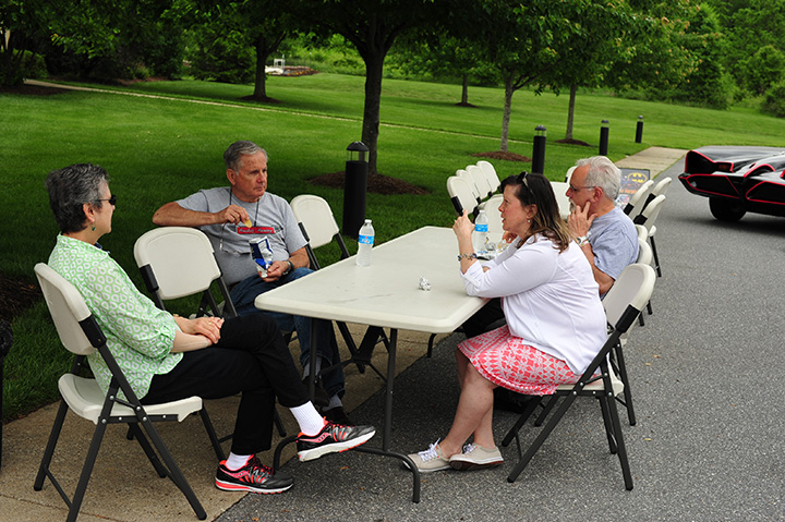 Mike Callison and Kathleen Keightley take a break and chat with fellow car enthusiasts.