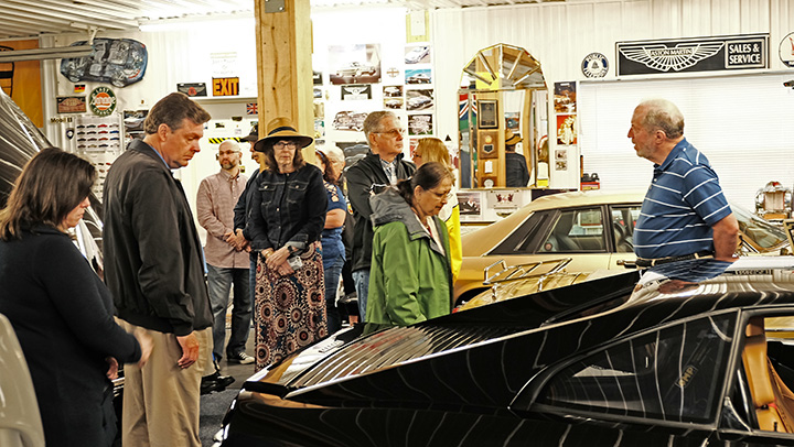 Members look over Jaguars, Bentleys and Mercedes in the collection.